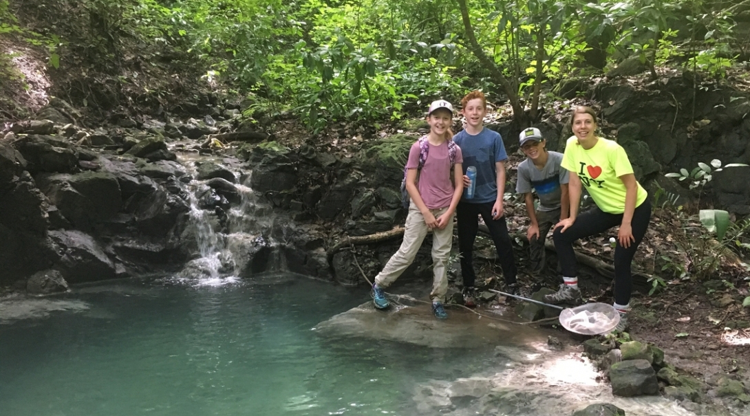 Middle school students stop by the waters edge while completing a wildlife survey in Costa Rica Projects Abroad volunteers take a break in the forest during their Conservation Project